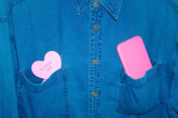 Blue shirt with a heart sticker in a pocket that says 