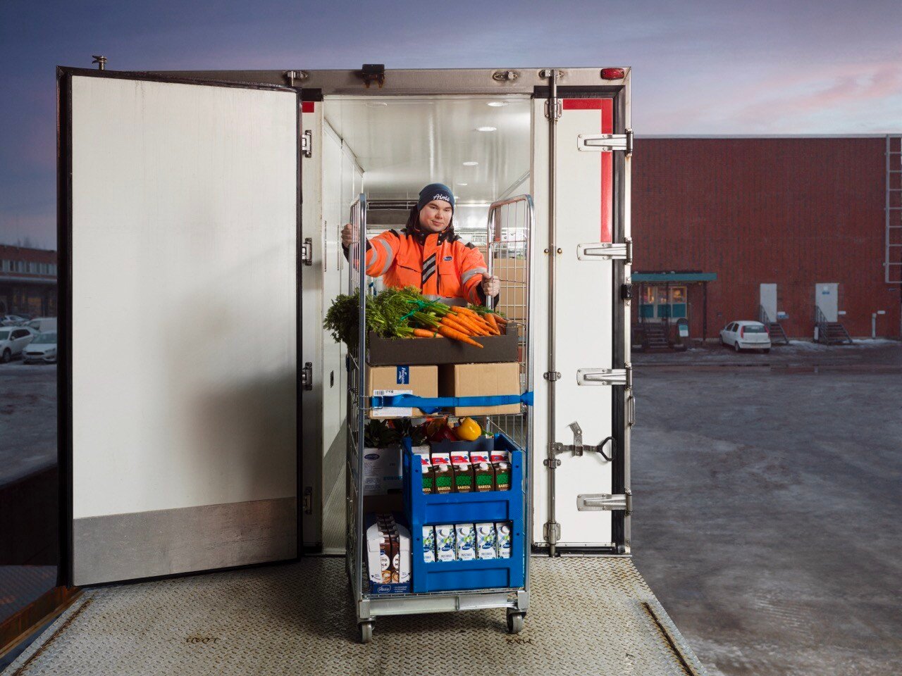 A person coming out from a truck with Valio Aimo's food products