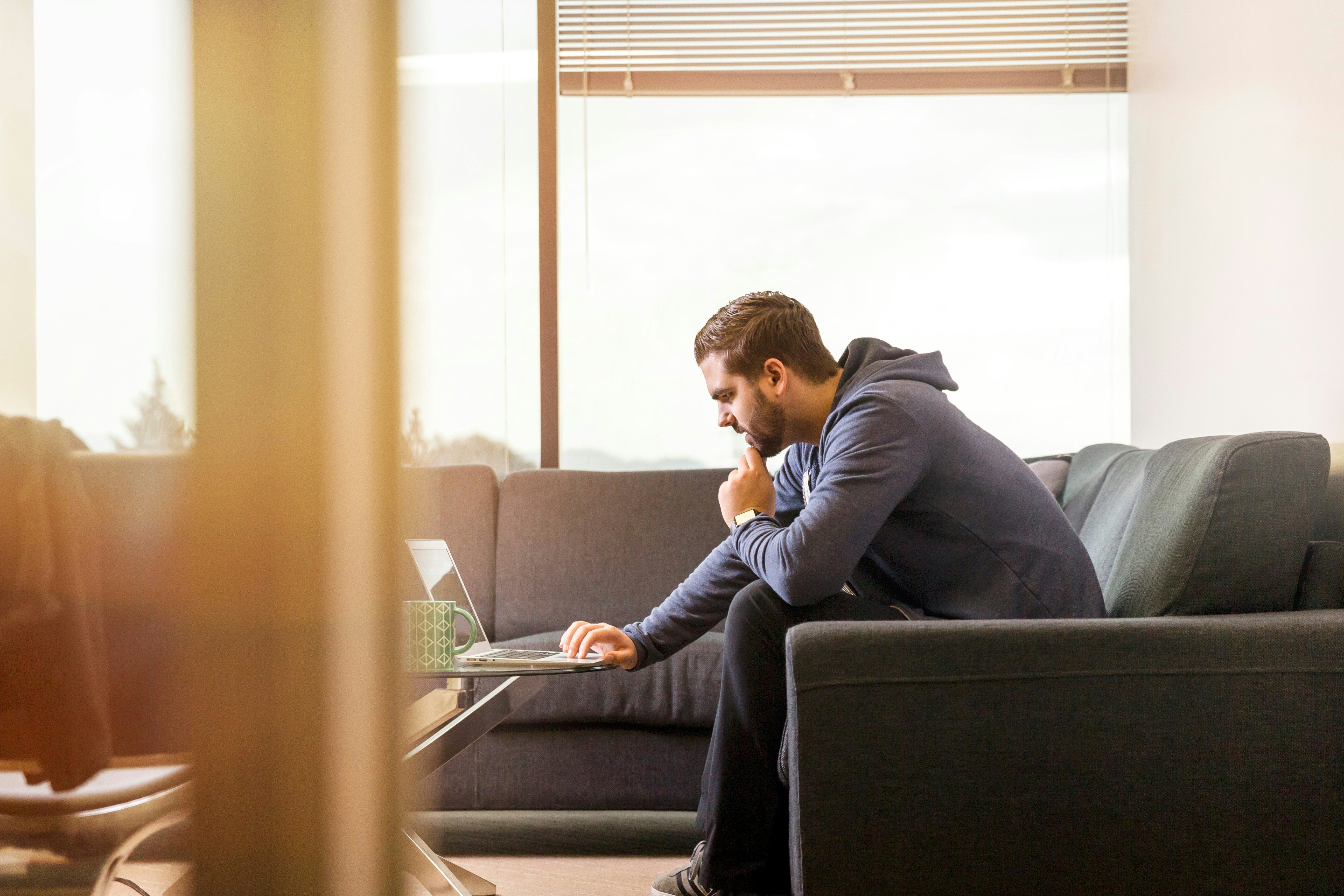 Person sitting on the sofa with laptop